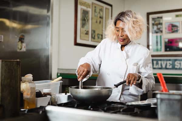 Barbara stirring food in frying pan
