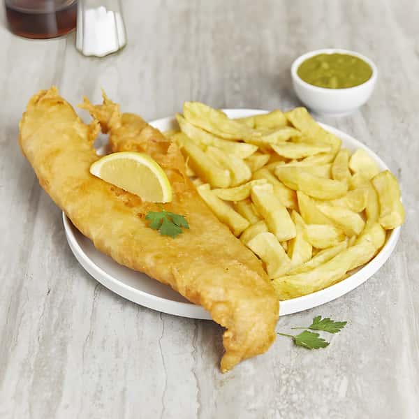 Fish and chips served with French fries and a lemon wedge.