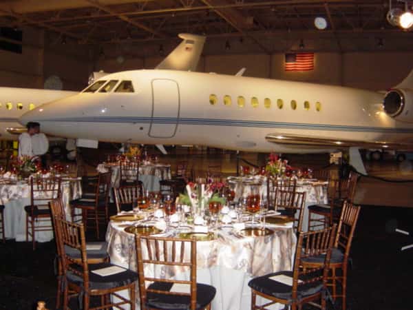 several tables in front of a plane