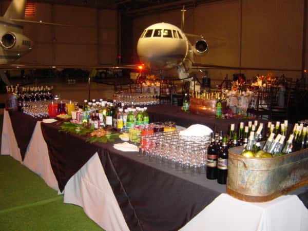 catering table in front of a plane