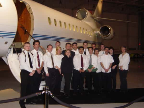 people standing in front of a plane