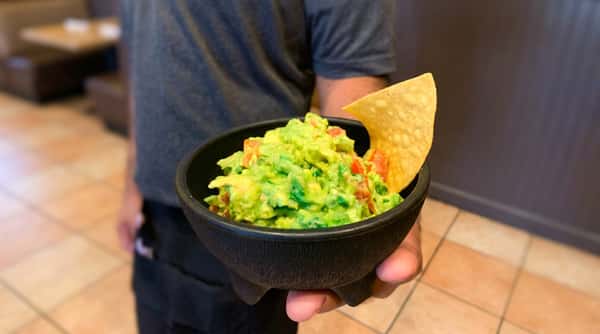 Fresh house-made guacamole served in a traditional molcajete with crispy tortilla chips at Maya Mexican Restaurant in Homewood and Alabaster, Alabama.