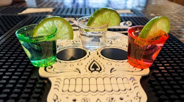 Premium tequila shots with fresh lime wedges and handcrafted cocktails at Maya Mexican Restaurant's full bar.