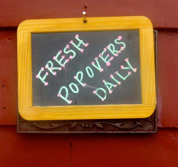 chalk board signs displaying Fresh Popovers Daily