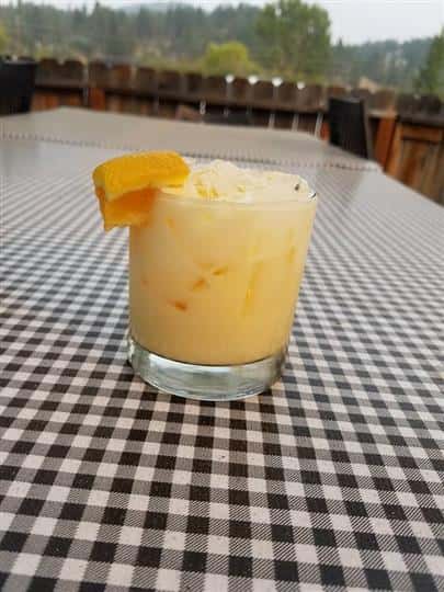 orange alcoholic beverage with orange peel