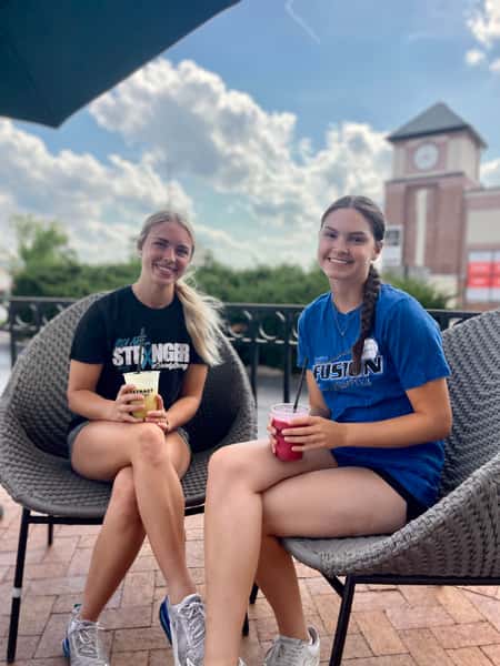 Two smiling customers enjoying drinks