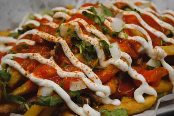 Thin-cut French fries topped with carne asada, shredded cheddar and jack cheese, cilantro, onions, homemade salsa roja, and drizzled with sour cream. (Only available on Thursdays) Upgrade your fries for our famous beer- battered fries for ($.99) cents more.
