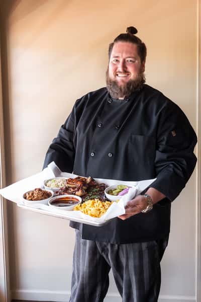 chef holding large platter of food