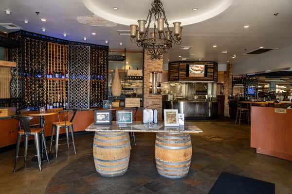 Interior hostess stand supported by wooden kegs.