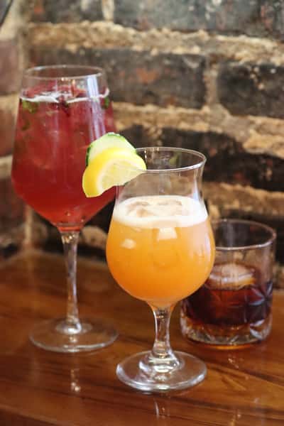 colorful craft cocktails with citrus garnish served on bar counter