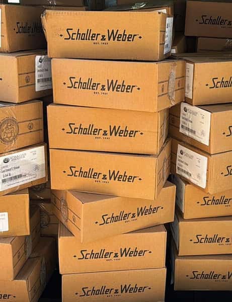 stacked boxes of Schaller & Weber products in restaurant storage area