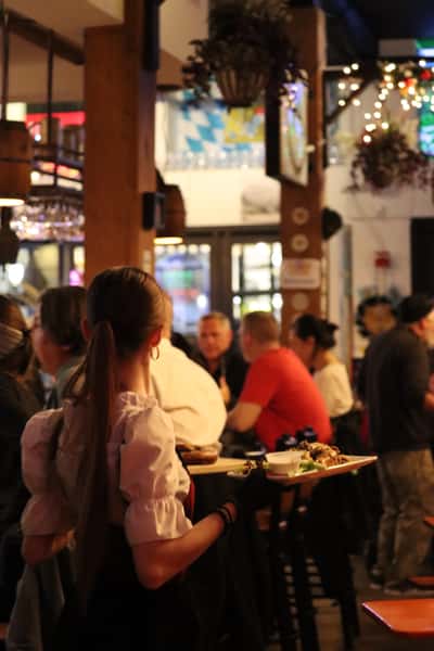 busy Bavarian restaurant dining room with guests seated and socializing