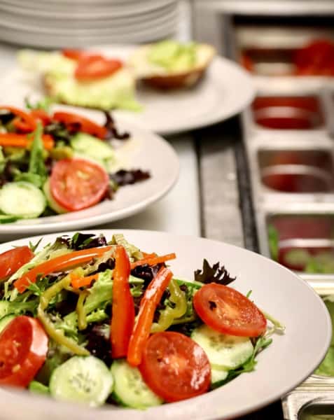 fresh garden salad with tomatoes, cucumbers, and mixed greens on a plate