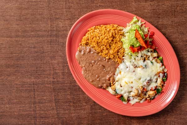 Grilled chicken fajita plate topped with melted cheese, served with refried beans, Mexican rice, and a side of lettuce, guacamole, and pico de gallo.