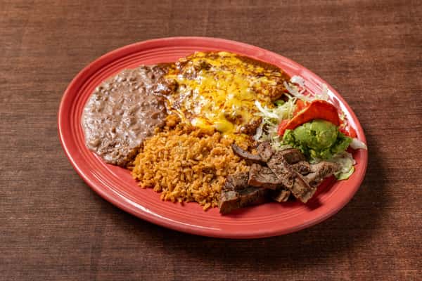 Tex-Mex combo plate featuring cheesy enchiladas, refried beans, Mexican rice, grilled steak strips, and a fresh salad with guacamole on a vibrant red plate.