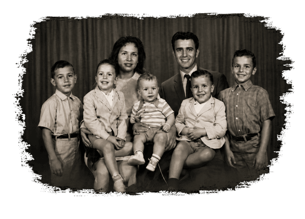 Vintage black-and-white family portrait featuring two parents and five young children, reflecting the heritage and family tradition behind La Poblanita Mexican Restaurant.