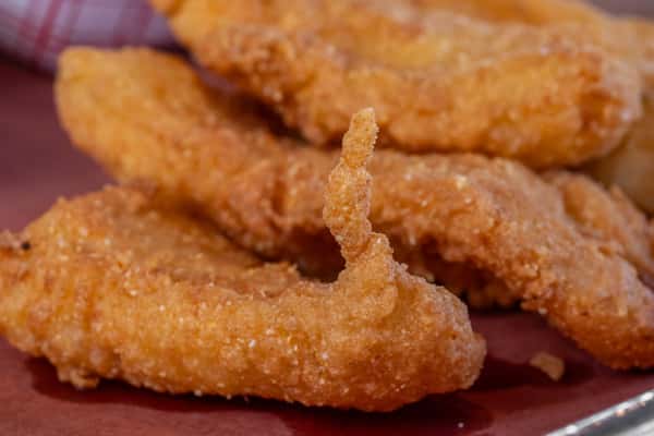 Crispy golden-brown chicken tenders freshly fried and served hot — ideal for comfort food branding or fast casual dining promotions.