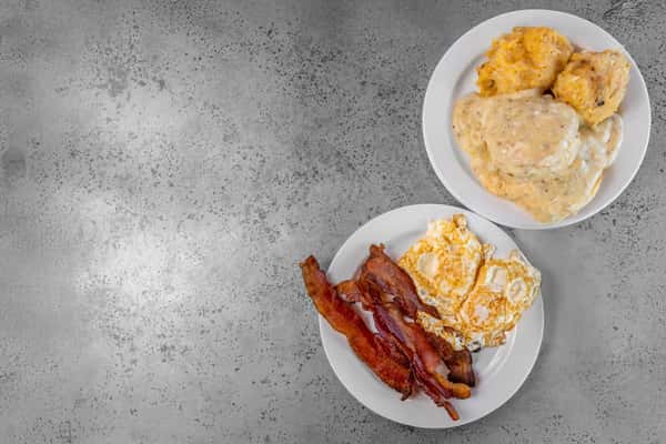 Classic American breakfast plates featuring biscuits and gravy, hash browns, bacon, and sunny side-up eggs — ideal for morning menu promotions and comfort food branding.