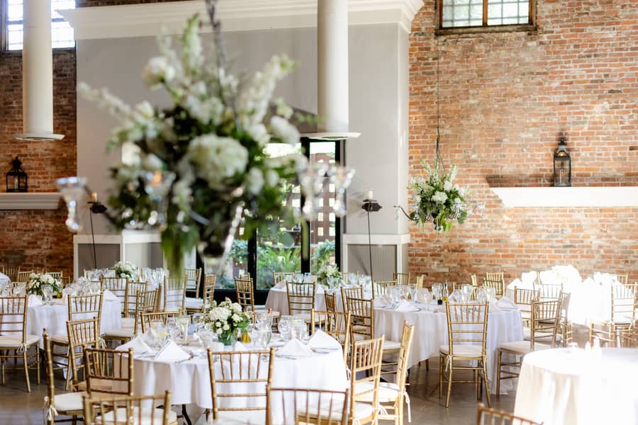 Candlelit reception tables set beneath the barrel ceiling