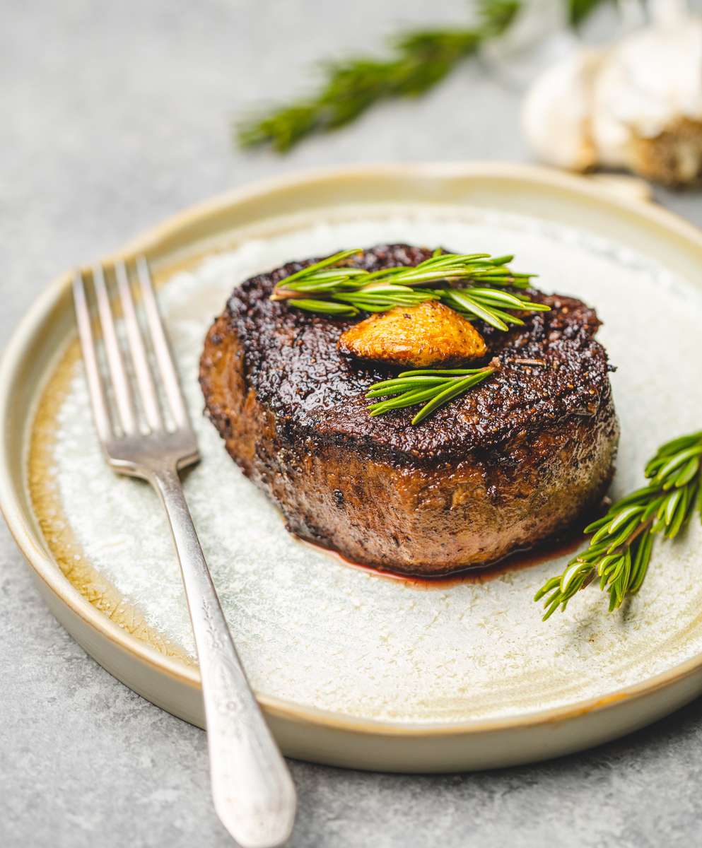 steak with fork and rosemary