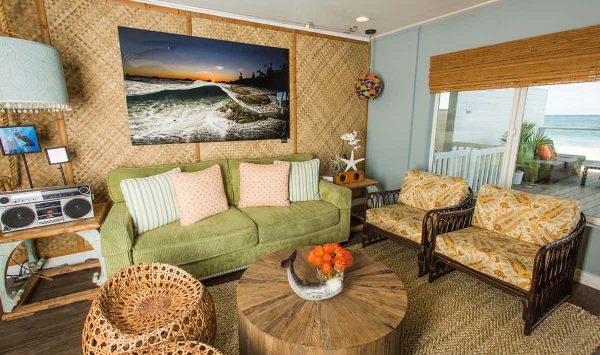 photo of green couch and chairs in living room of xs bungalow