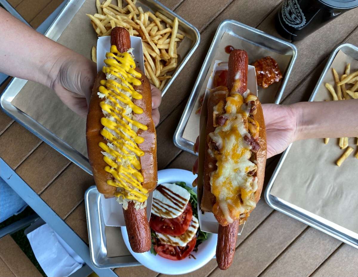 Two foot-long hot dogs with toppings
