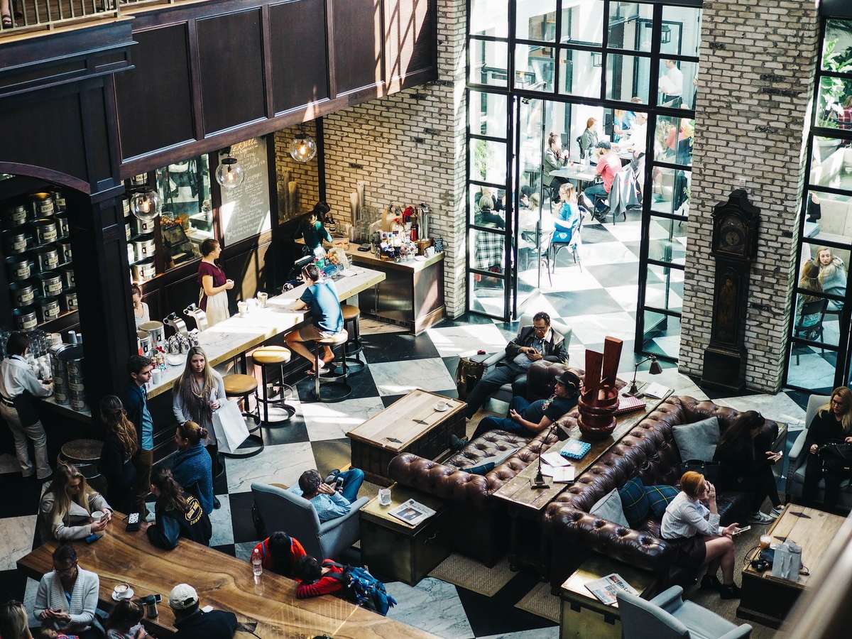 People enjoying coffee, working, and socializing at their favorite coffee shop.