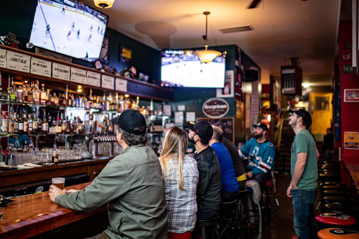 guys watching hockey at bar