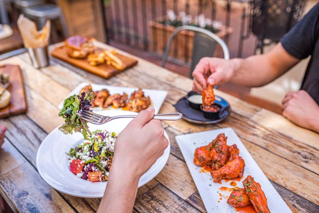 Multiple meals being enjoyed by guests