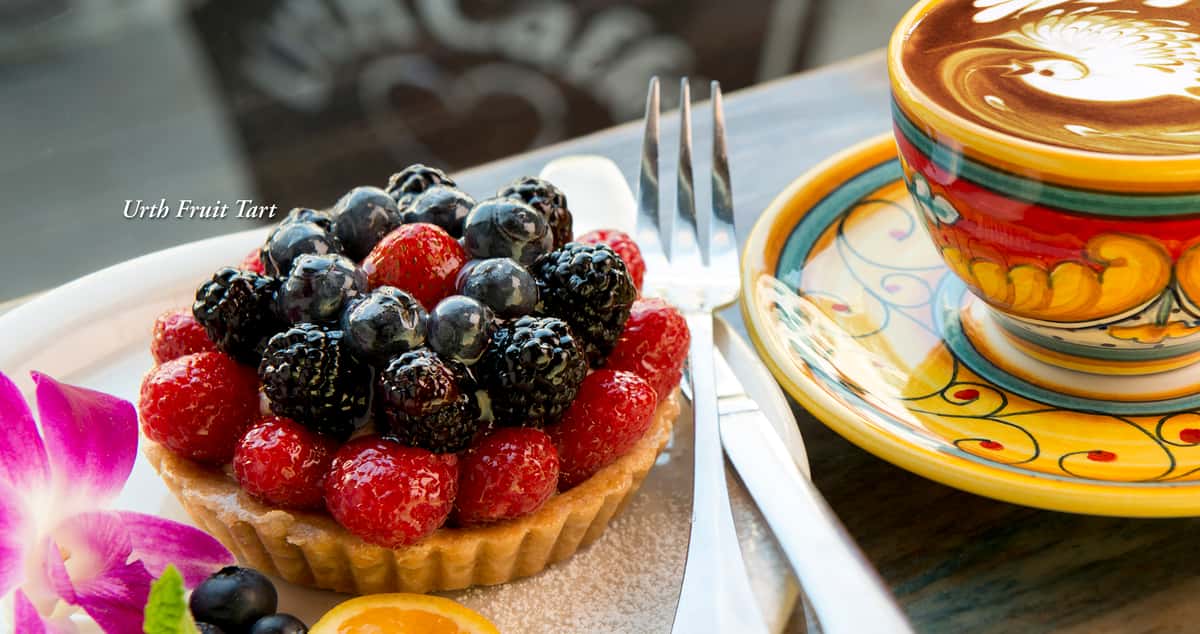 Urth Fruit tart with decorative cup of Mocha latte nearb