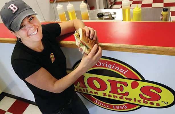 woman holding sandwich