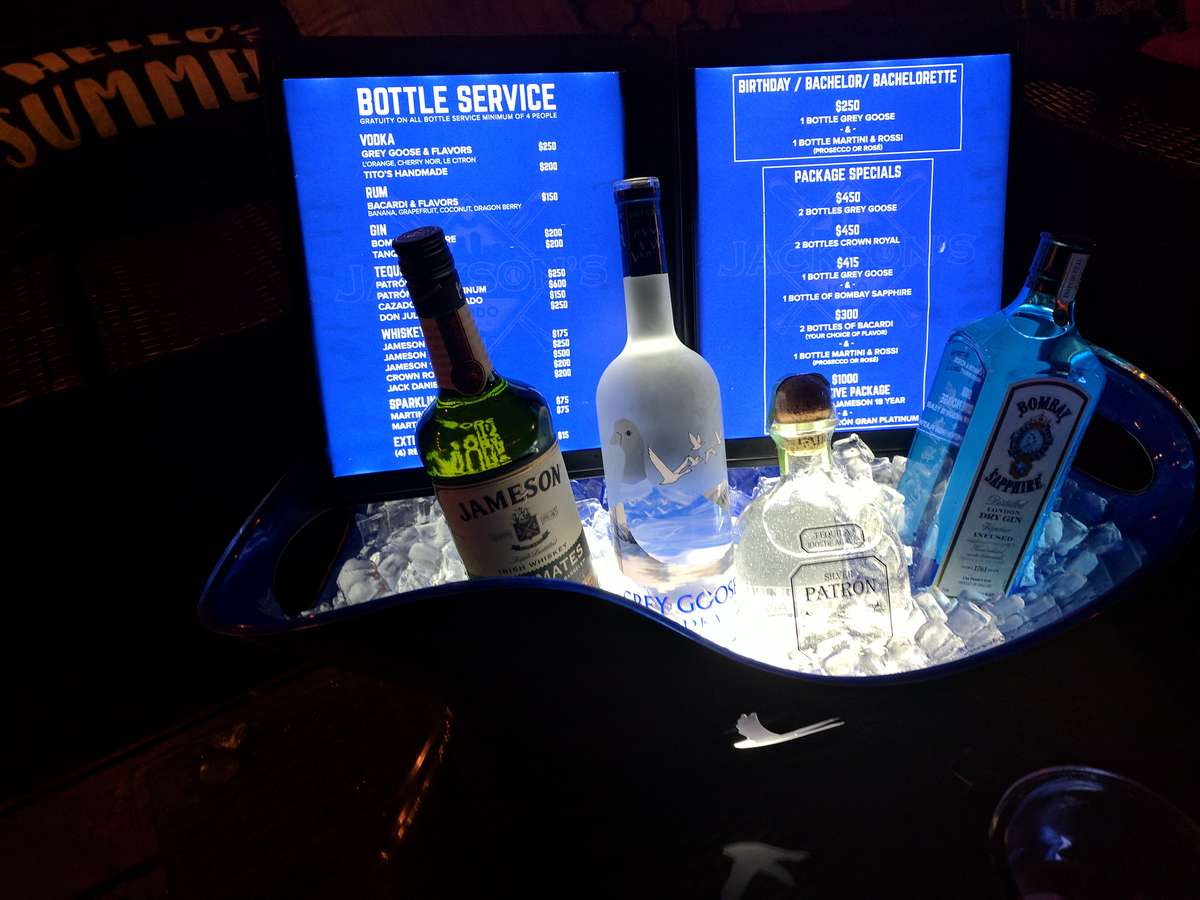 bottles of liquor arranged on a bar