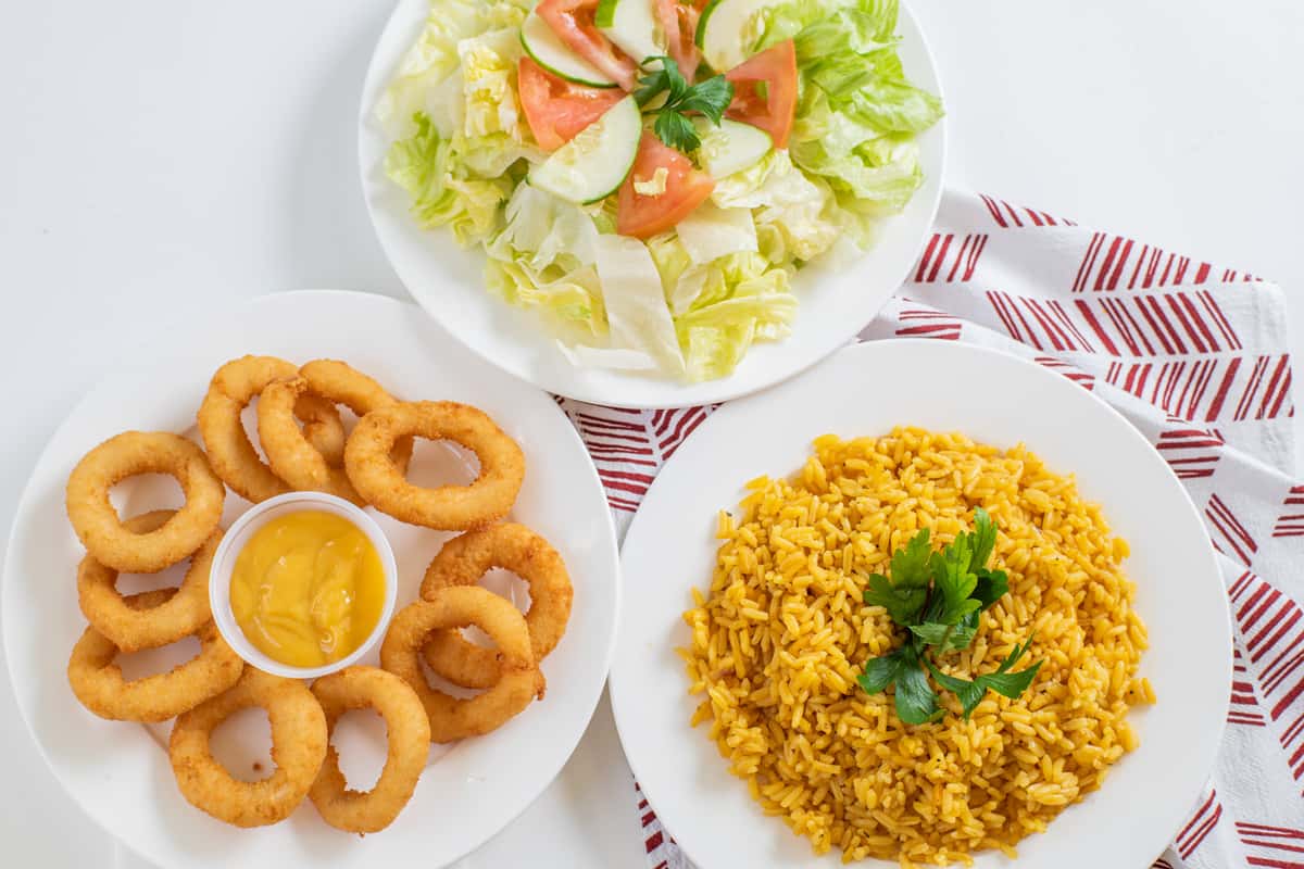 Rice, onion rings and salad