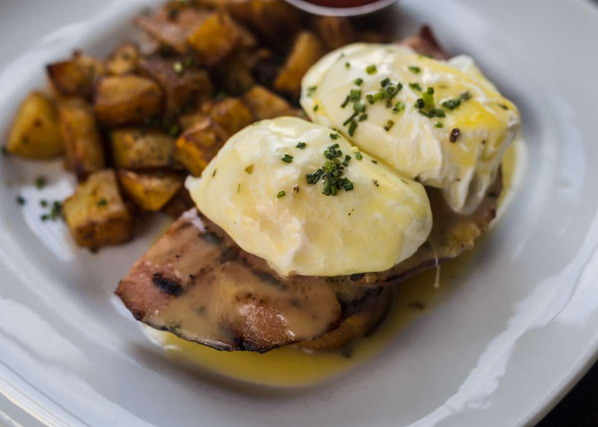 Honey Baked Ham Eggs Benedict w/ Poached Eggs, Hollandaise Sauce & House Potatoes