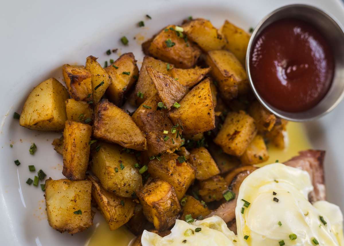 Honey Baked Ham Eggs Benedict w/ Poached Eggs, Hollandaise Sauce, and Roasted Potatoes