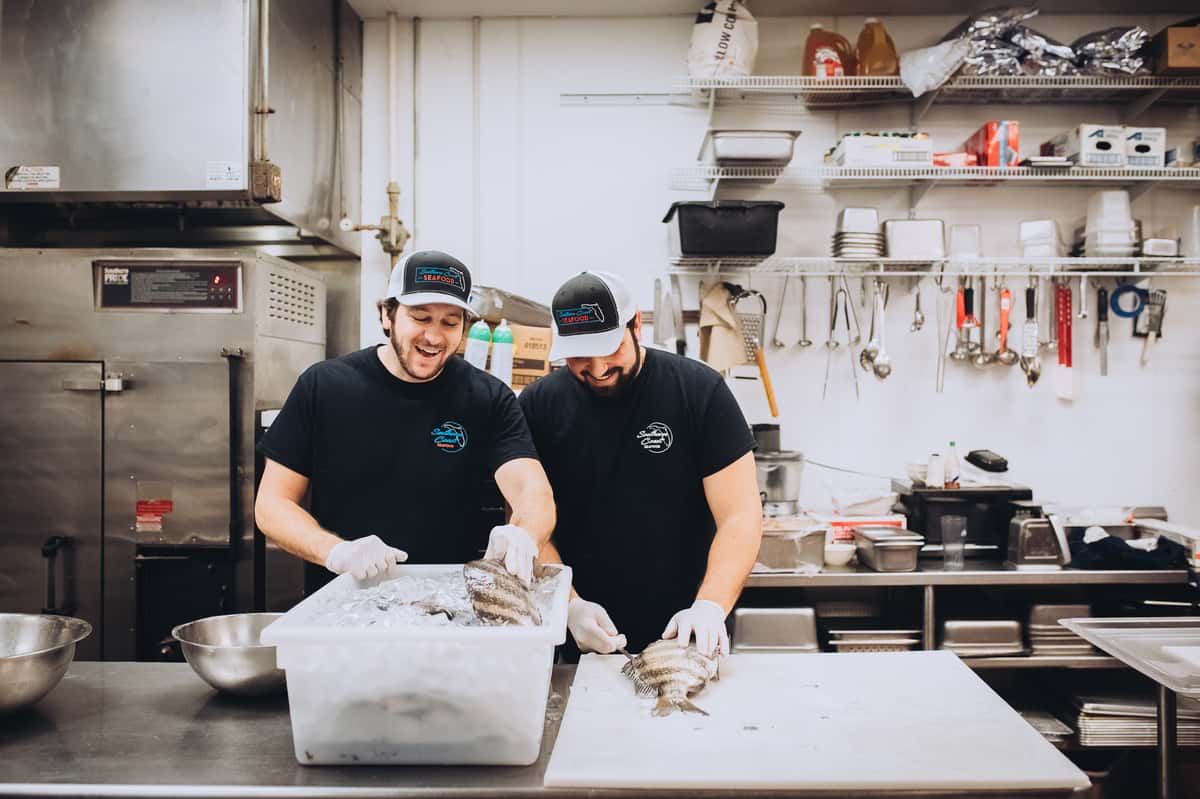 chefs preparing seafood