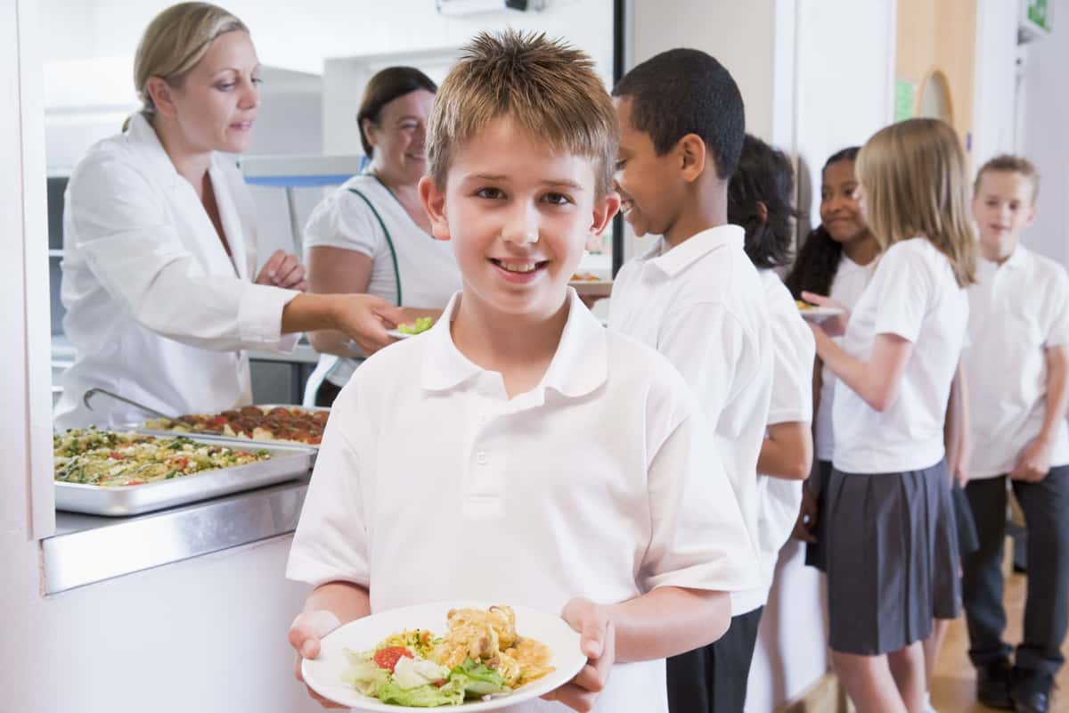 child holding a plate of food