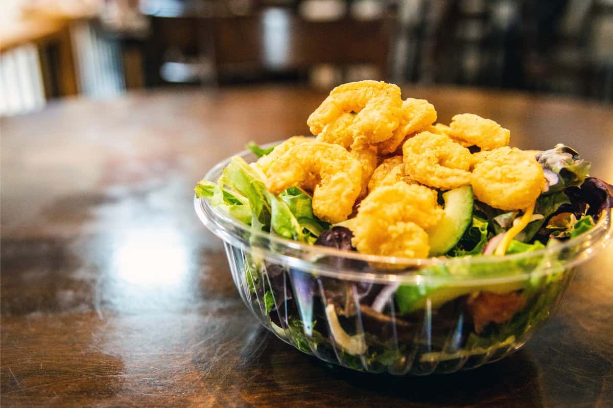House salad topped with Fried Shrimp