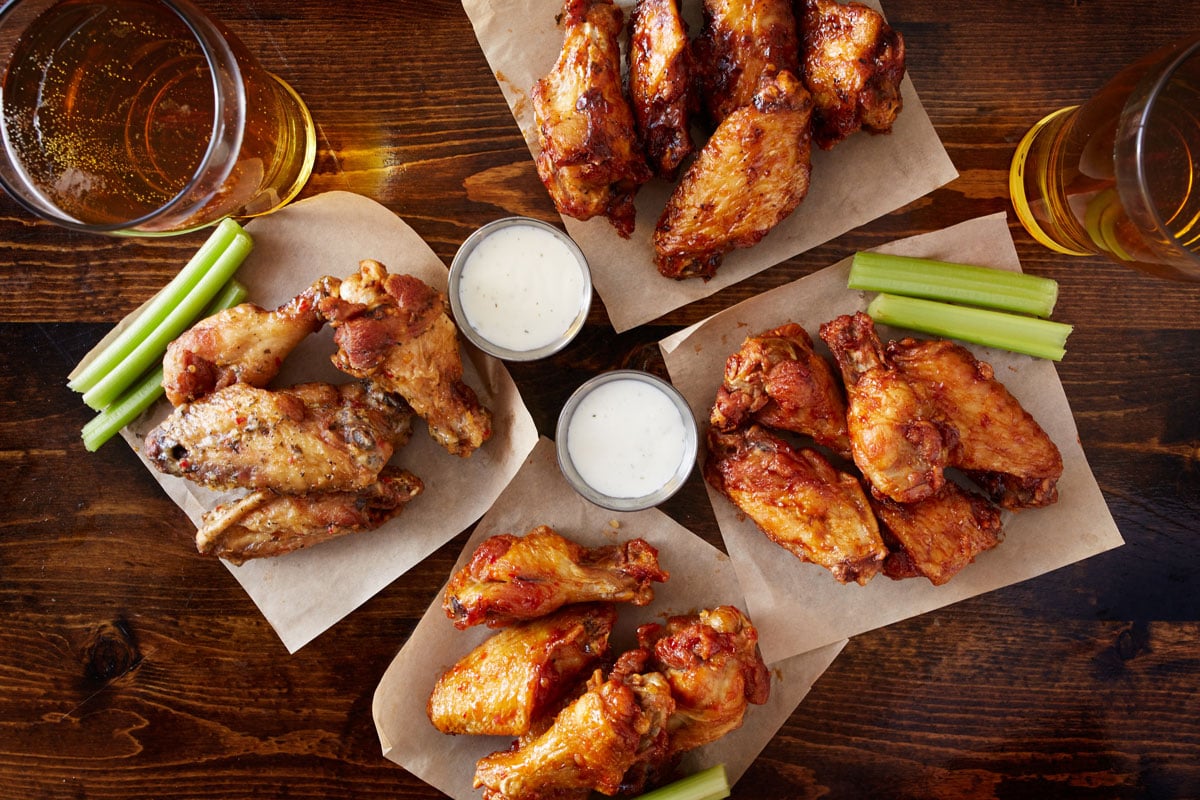 Four plates of chicken wings
