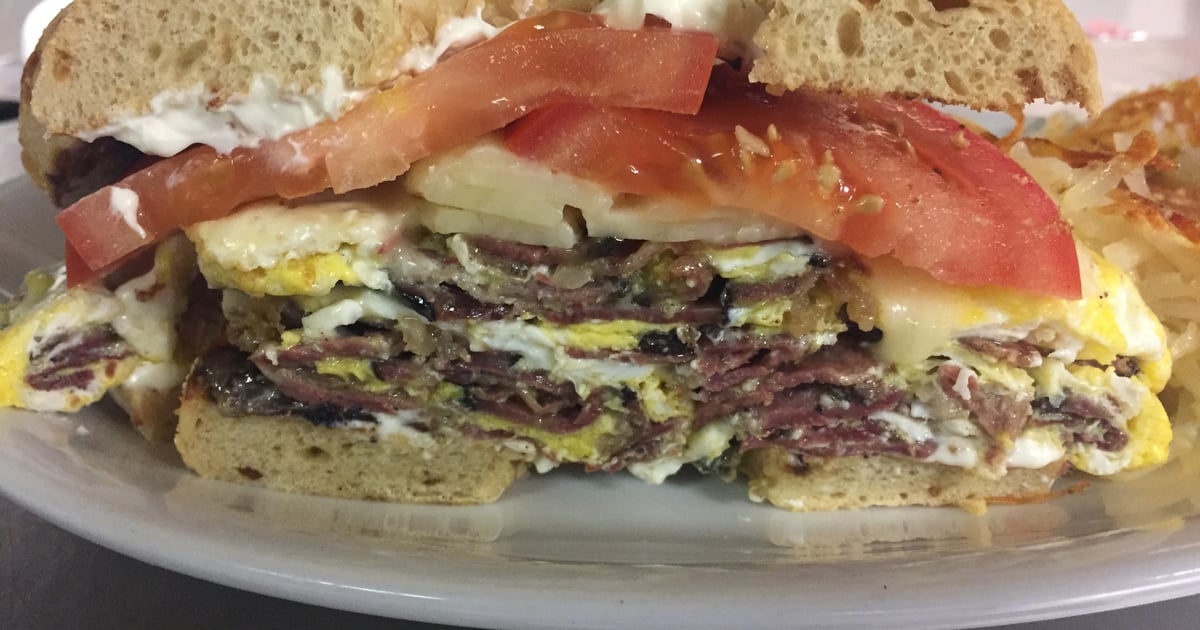 Pastrami And Fried Egg Sandwich On A Toasted Bagel With Melted Swiss Cheese Breakfast Manhattan In The Desert American Restaurant In Palm Springs Ca