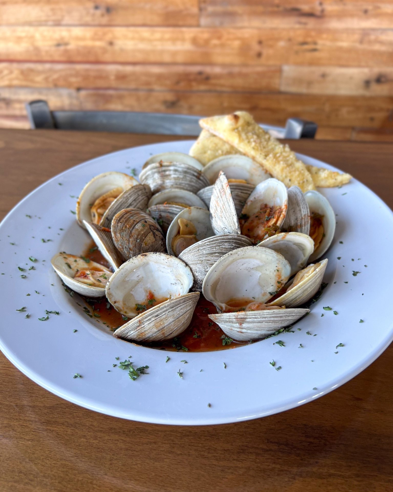 Wood Fired Steamed Clams recipe served on a plate, by Vice Restaurant Wood Fired Steamed Clams recipe served on a plate, by Vice Restaurant