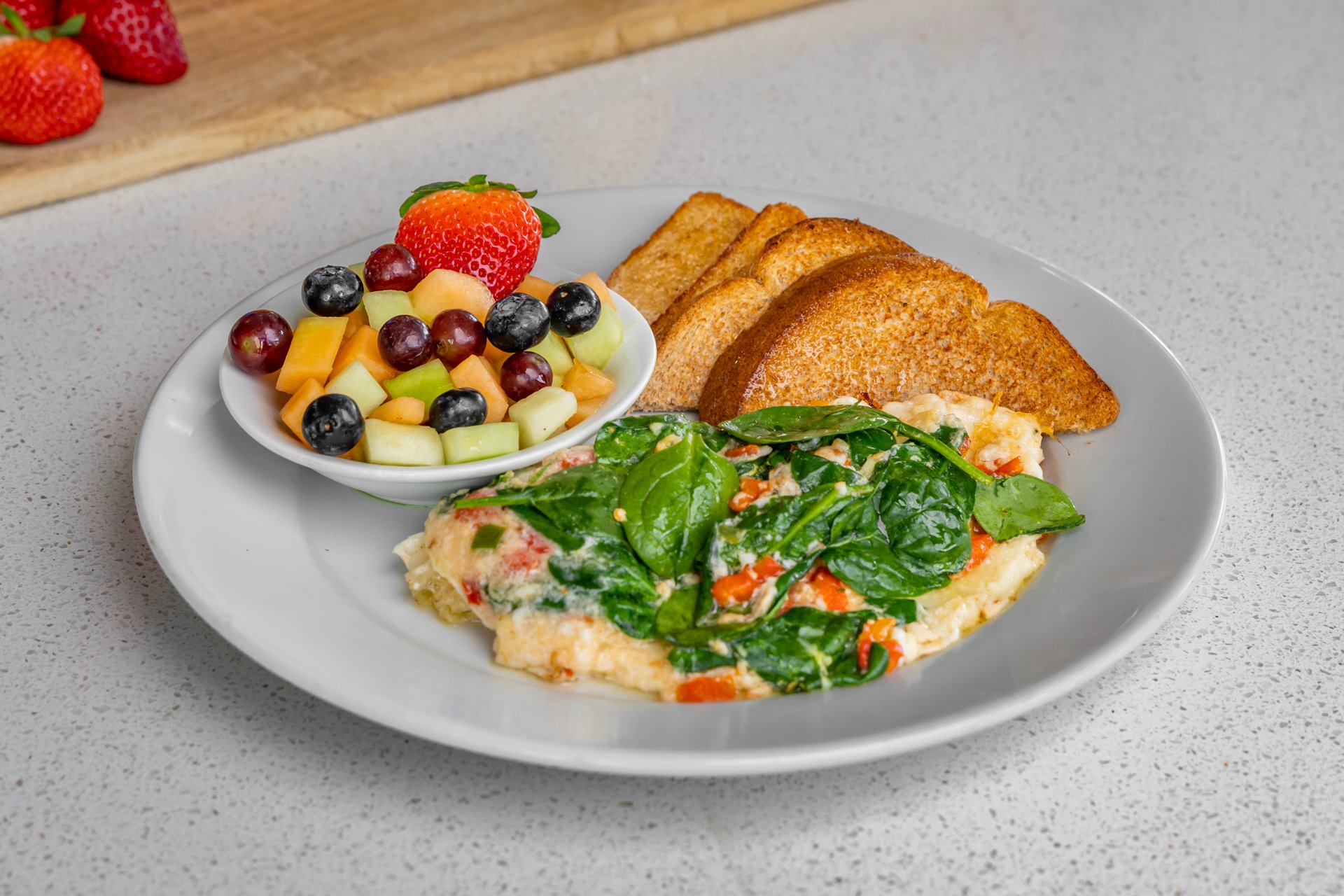 Veggie omelet with fruit and toast