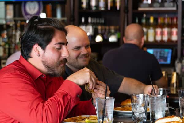 Group enjoying drinks and food at the bar