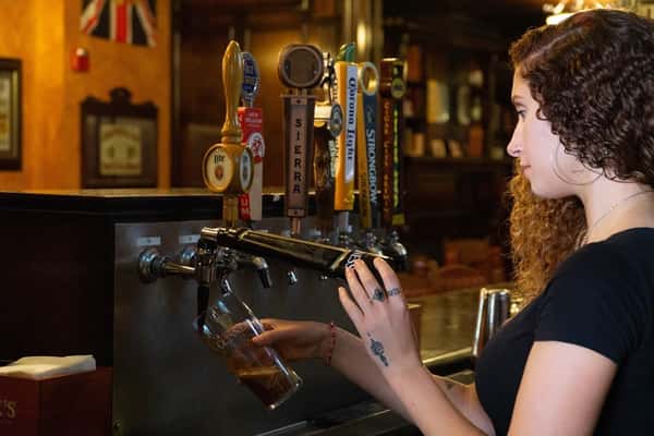 Staff pouring beer from a tap