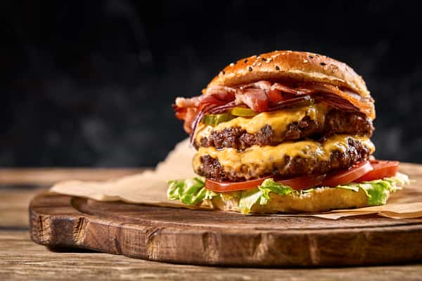 juicy-american-burger-hamburger-cheeseburger-with-two-beef-patties-with-sauce-basked-black-space
