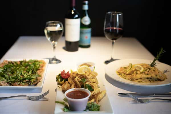 Two meals and appetizer paired with wine