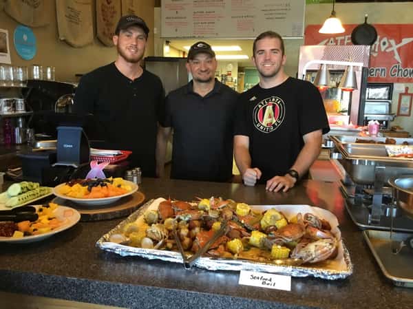 men standing behind counter