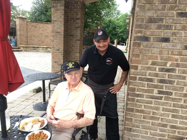 chef standing next to ww2 vet