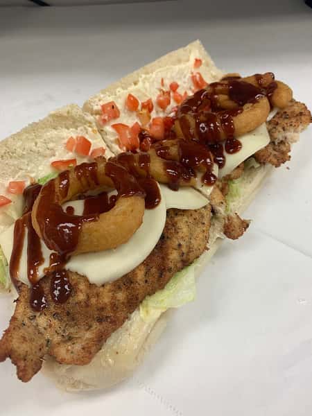 sandwich with onion rings and barbecue sauce