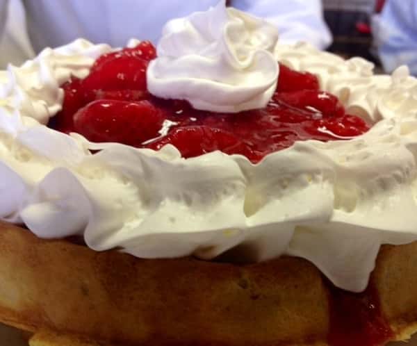 waffle topped with strawberries and whipped cream